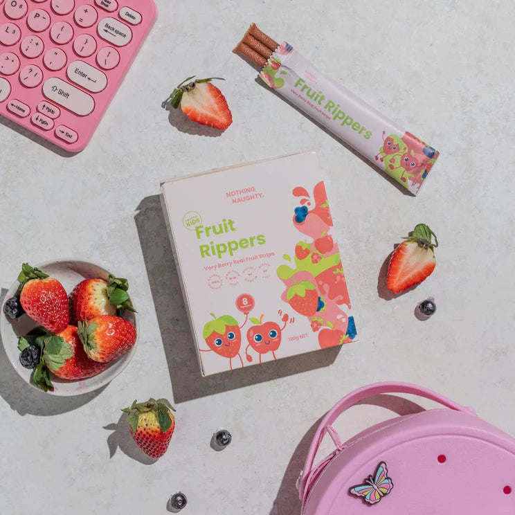 Fruit Rippers packaging with strawberries and a pink bag on a light surface