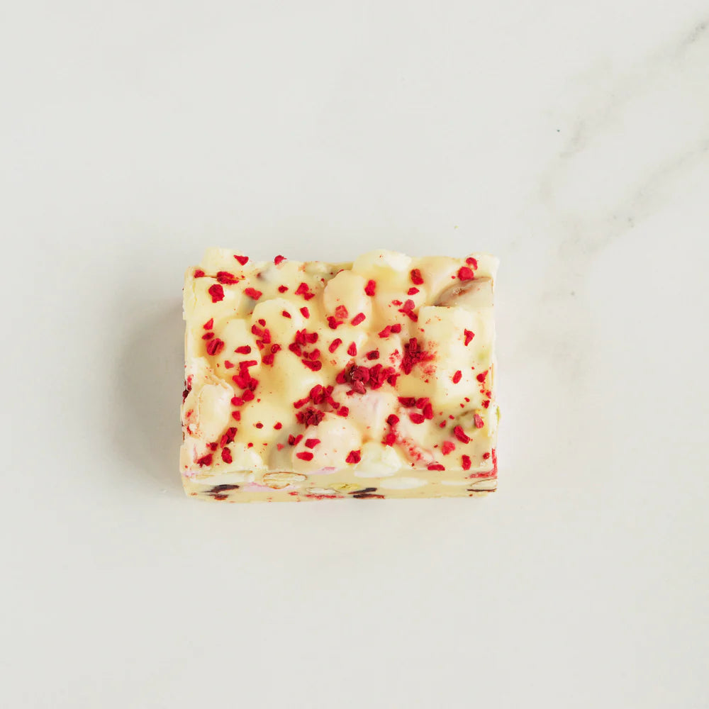 Bar of soap with red specks on a white background