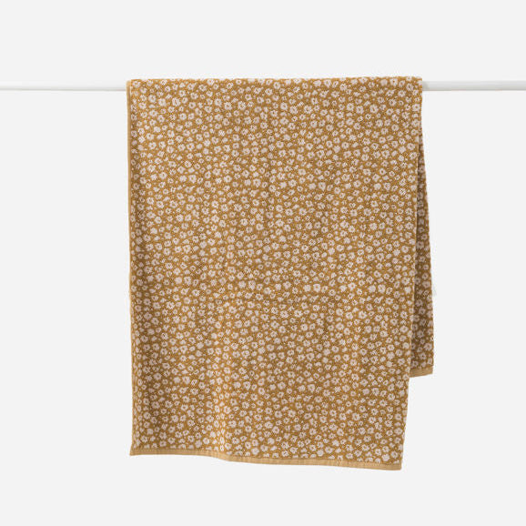 Brown towel with small pattern on a white background