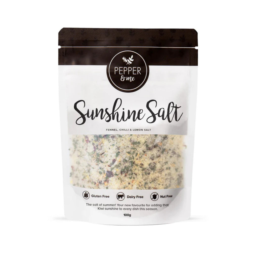 White and black pouch with clear window displaying a fennel, chilli & lemon salt mix from Pepper & Me labelled "Sunshine Salt"