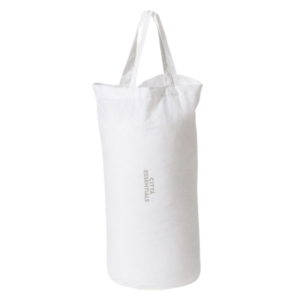 A white cylinder shaped bag labelled "Cittā Essentials" 