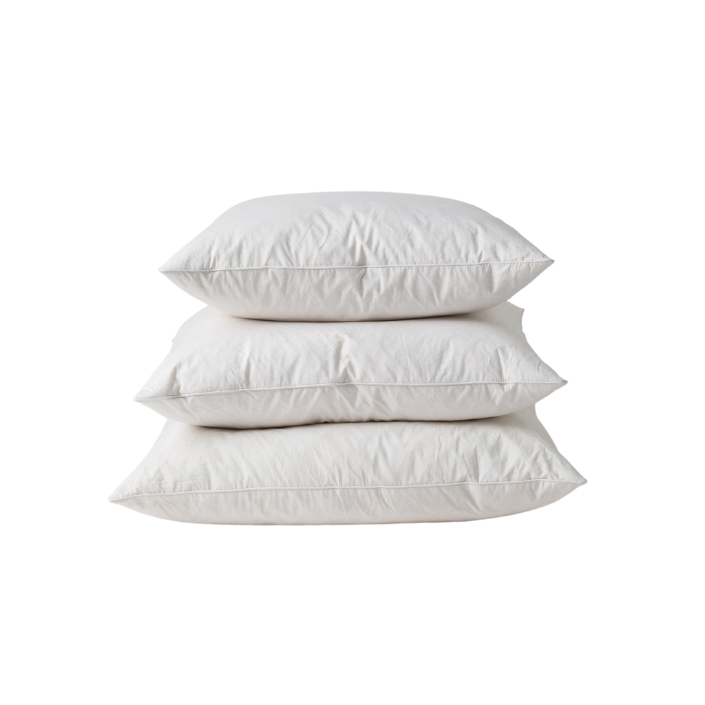 A stack of three white pillow inners