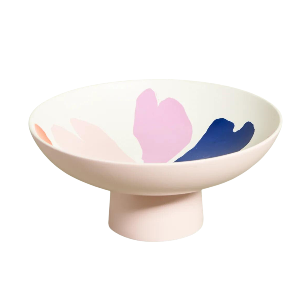 A pink pedestal bowl with a painted design inside it against a white background 