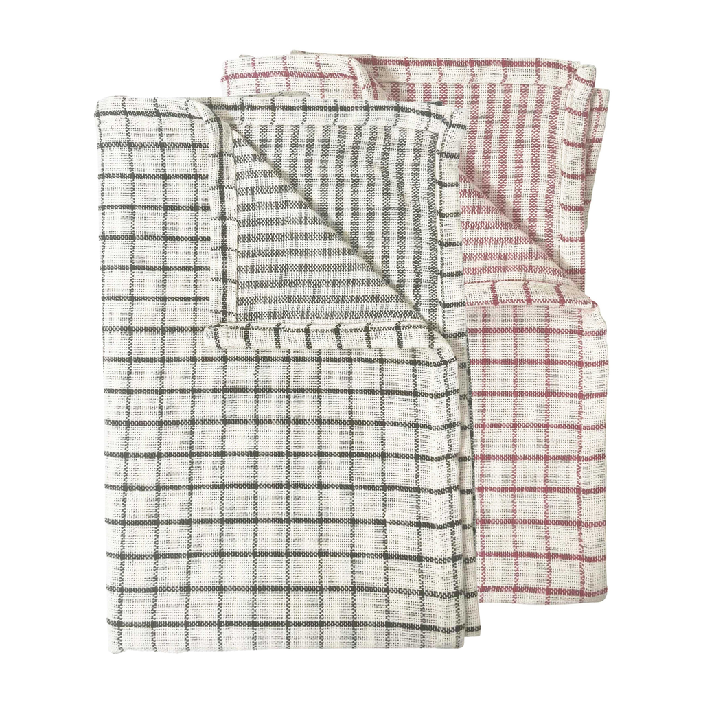 A set of two check patterned tea towels, one being white and green and the other red and green against a white background. 
