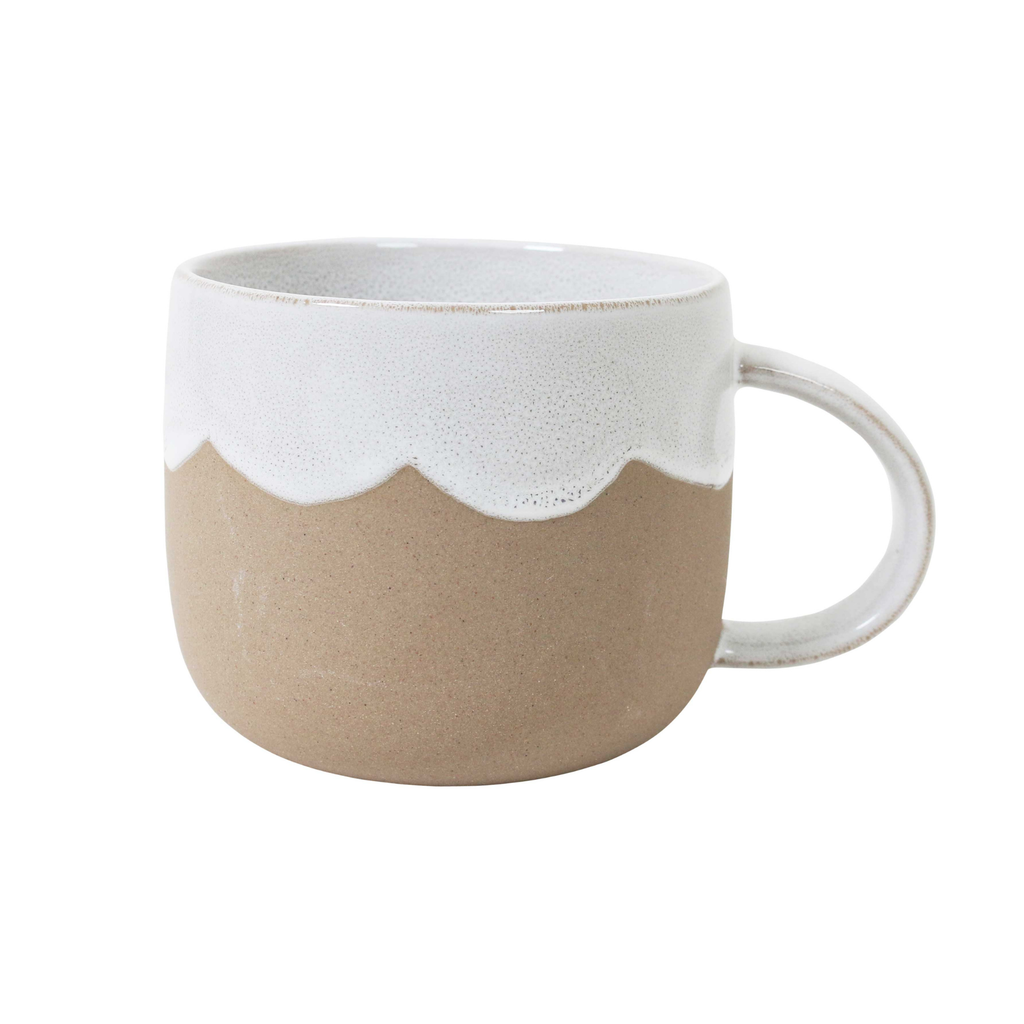 A brown ceramic mug with a dipped edge and inner with white glaze and a scalloped edge against a white background  